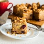 A slice on nectarine cake on the table.