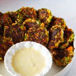 Vegetable patties with dipping sauce.