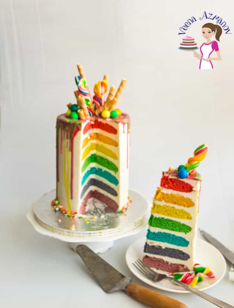 A slice of a rainbow cake on a plate.