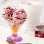 Scoops of mixed berry no churn ice cream in a bowl