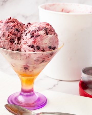 Scoops of mixed berry no churn ice cream in a bowl
