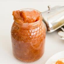 A jam jar with spoon.