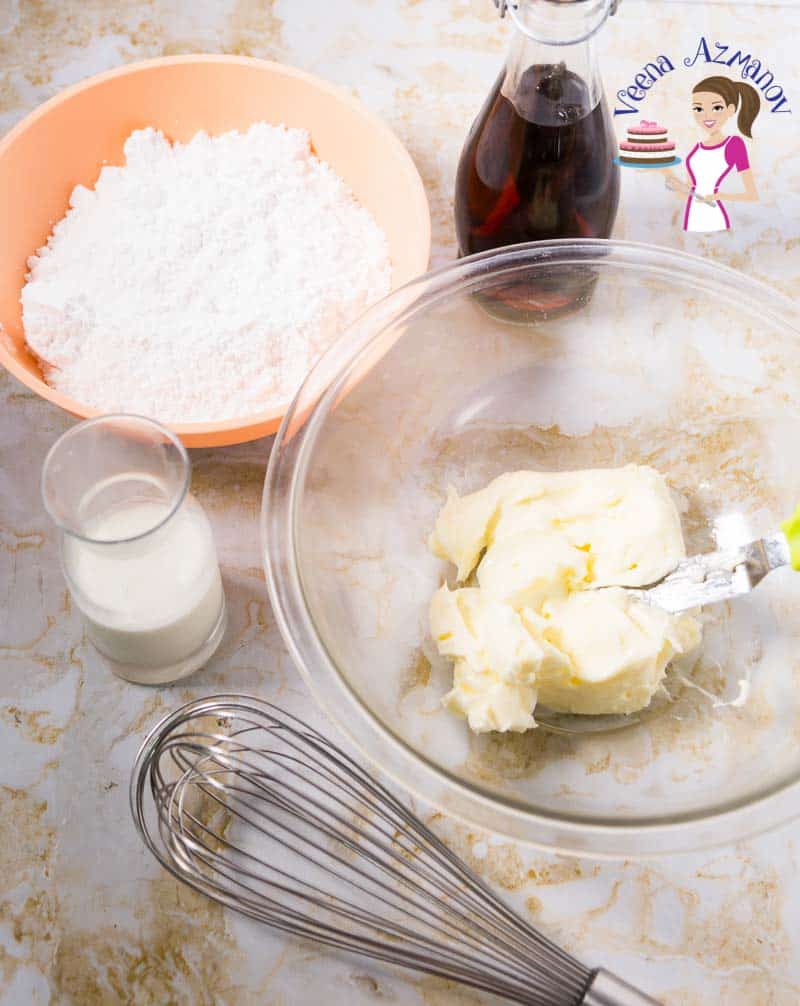 A glass bowl with butter next to a plastic bowl with powdered sugar.