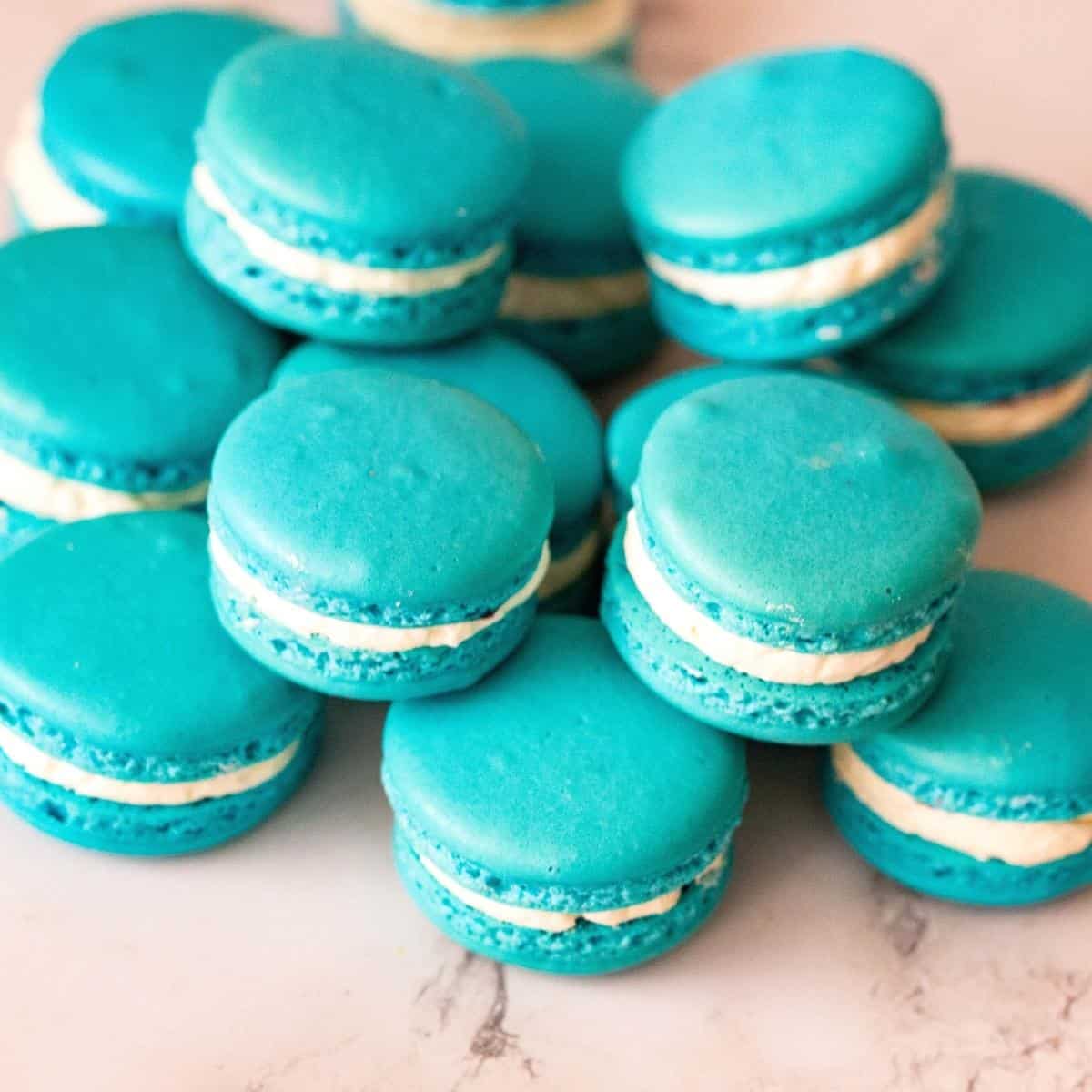 Stack of blue frosted macarons.