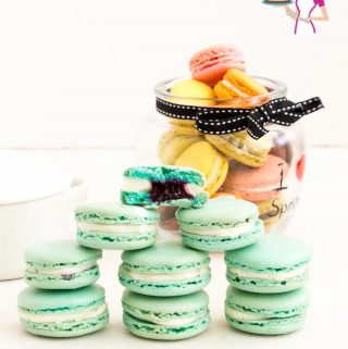 An image optimized for social media share for these blueberry macarons filled with blueberry filling and Swiss meringue buttercream.