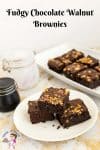Three chocolate brownies on a plate.