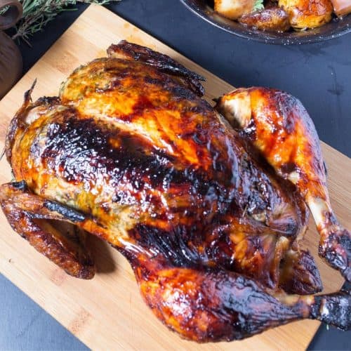 A roast chicken on a board