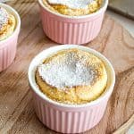A pumpkin soufflé in pink ramekin.