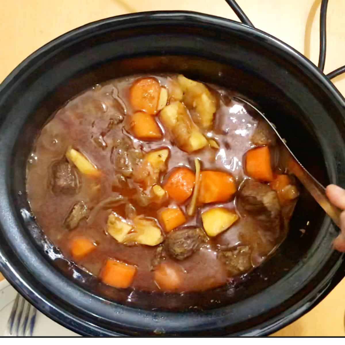 A slow cooker with beef stew.