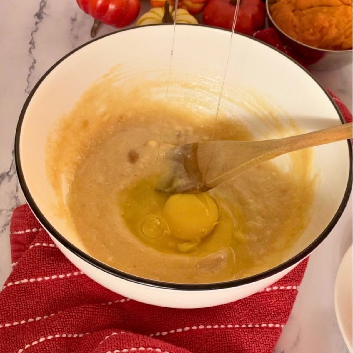 A bowl with cream butter sugar and eggs.