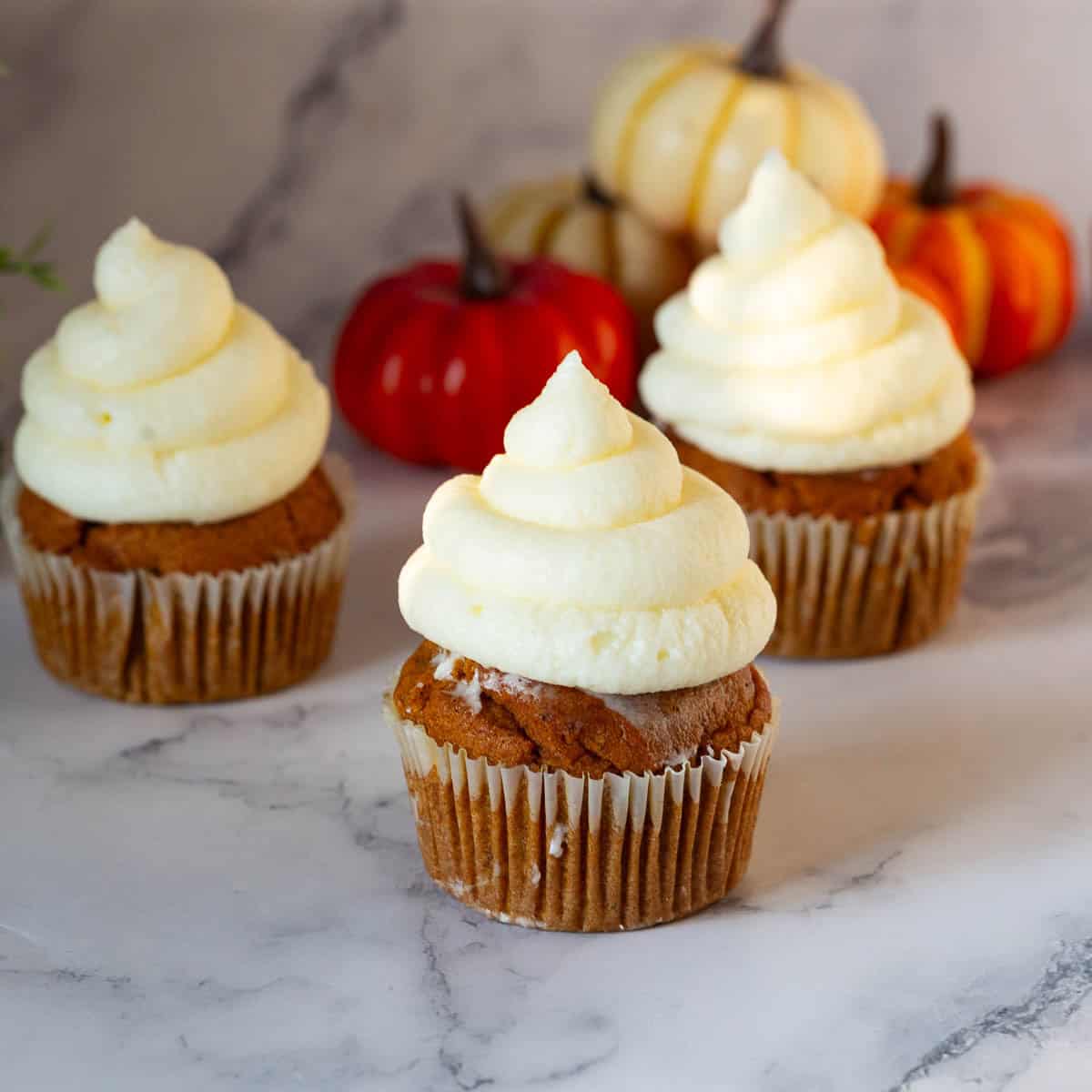 Cupcakes frosted with cream cheese frosting.