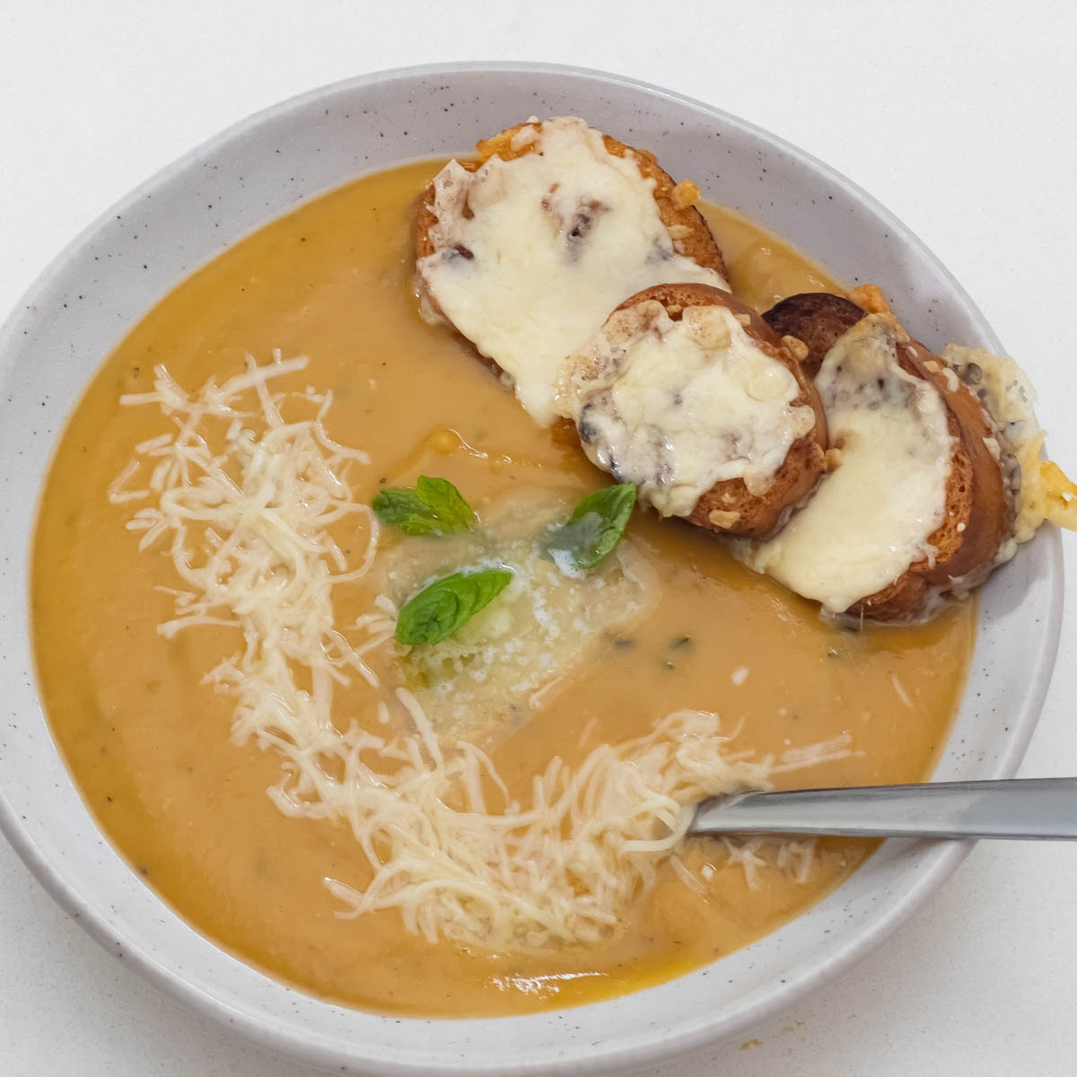 A bowl with orange soup.