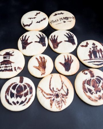 Stenciled cookies on a board.