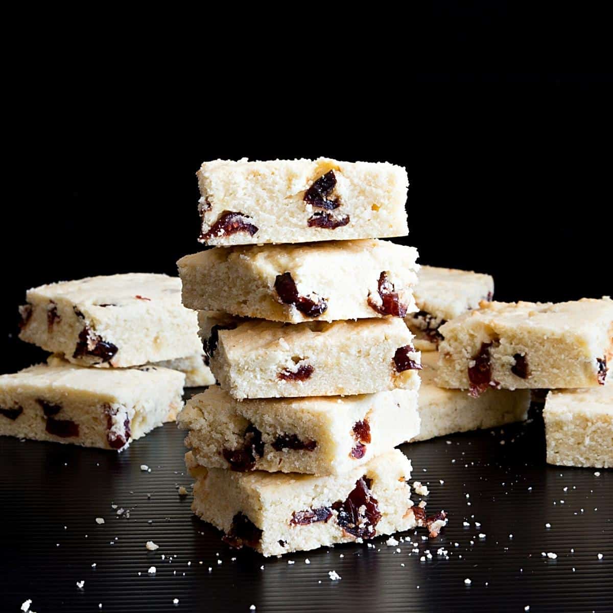 Stack of bars with shortbread and cranberries.