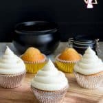 Cupcakes with buttercream frosting on a round board.