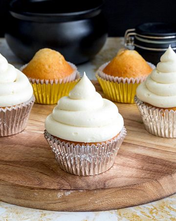 Eggnog frosted cupcakes on a board.