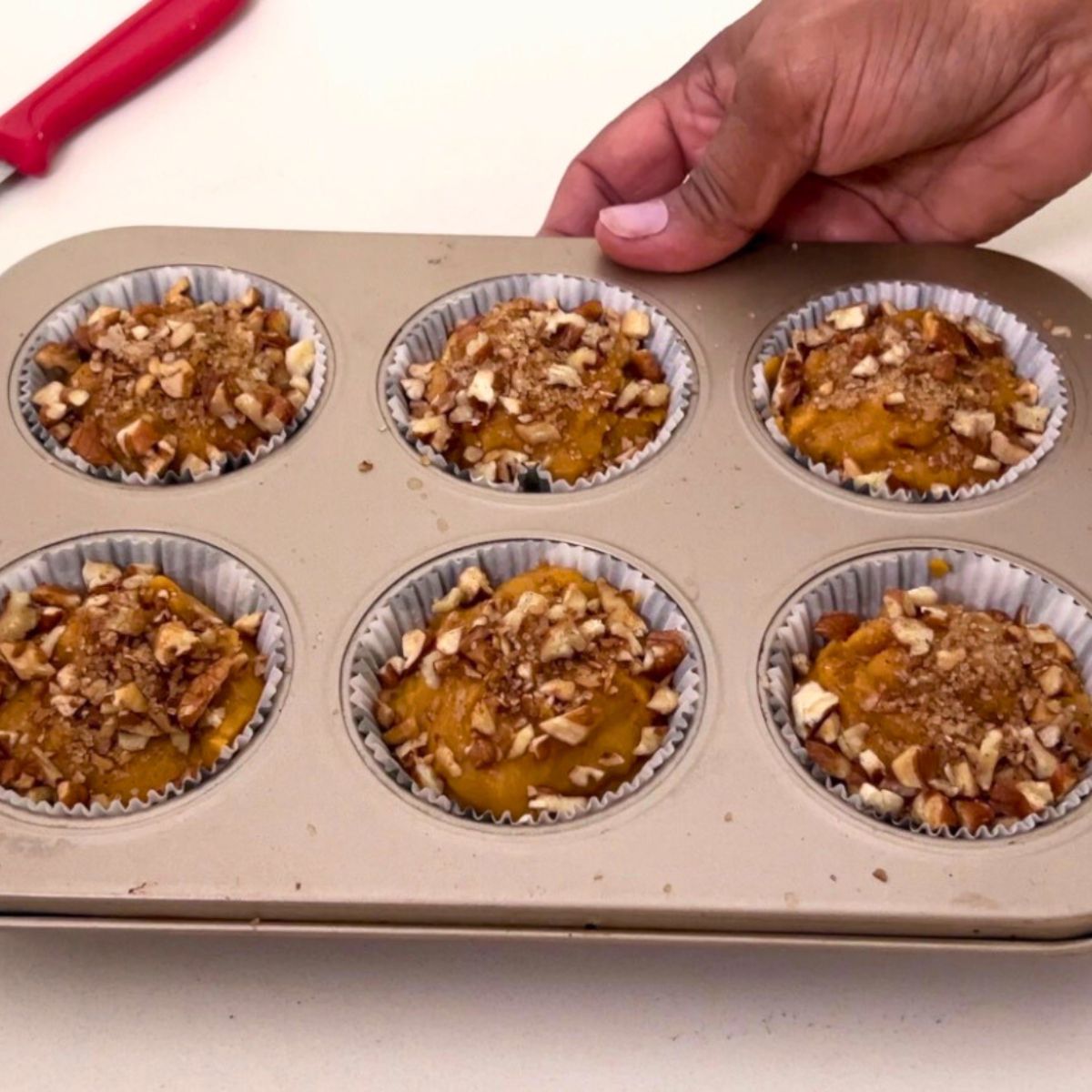 Pumpkin muffins in muffin pan ready for baking.