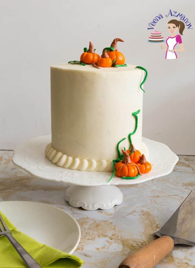 Celebrate Thanksgiving this fall with a pumpkin spice cake with cream cheese frosting topped with fondant pumpkins