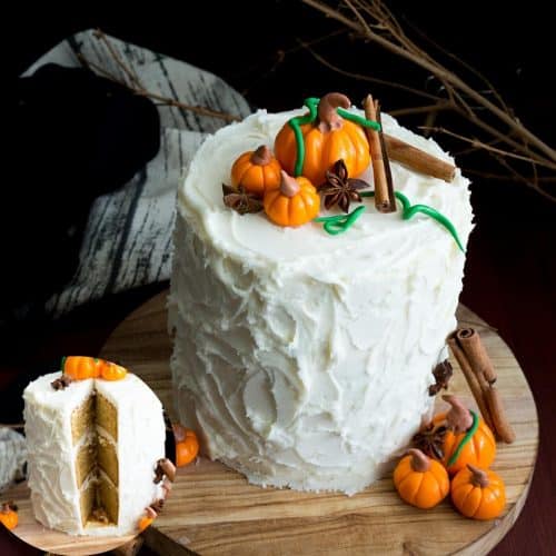 Frosted white cake with fondant pumpkins on top