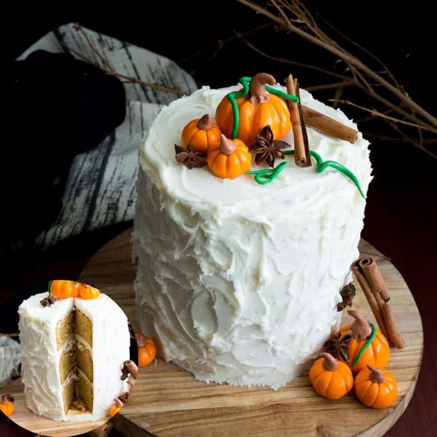 Frosted white cake with fondant pumpkins on top