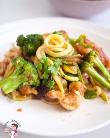 A plate of chicken with Broccoli and noodles.