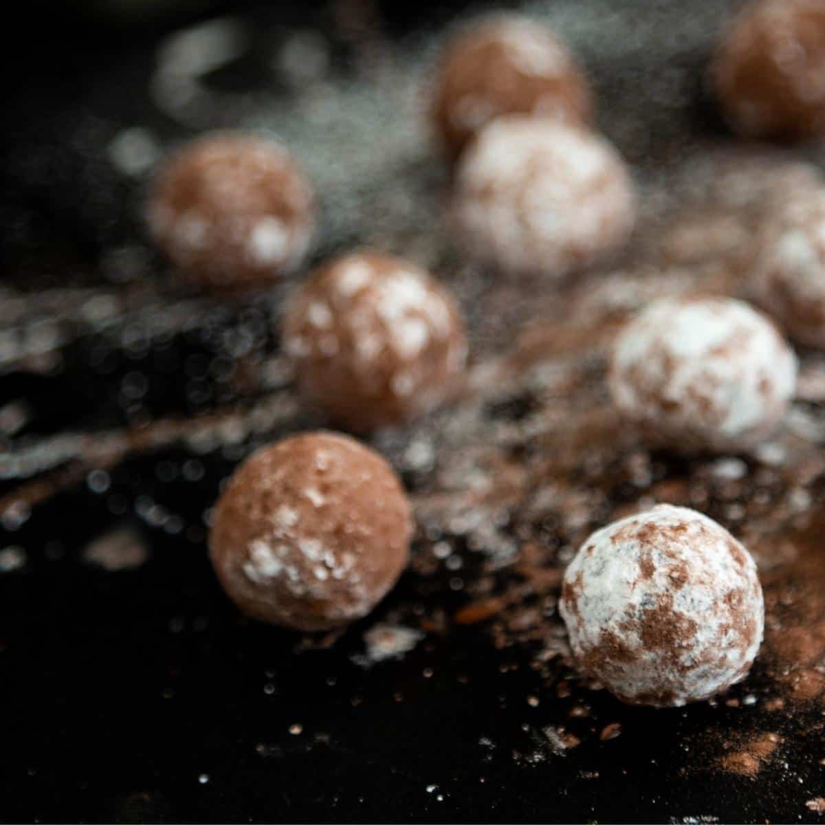 Marzipan truffles on a black table