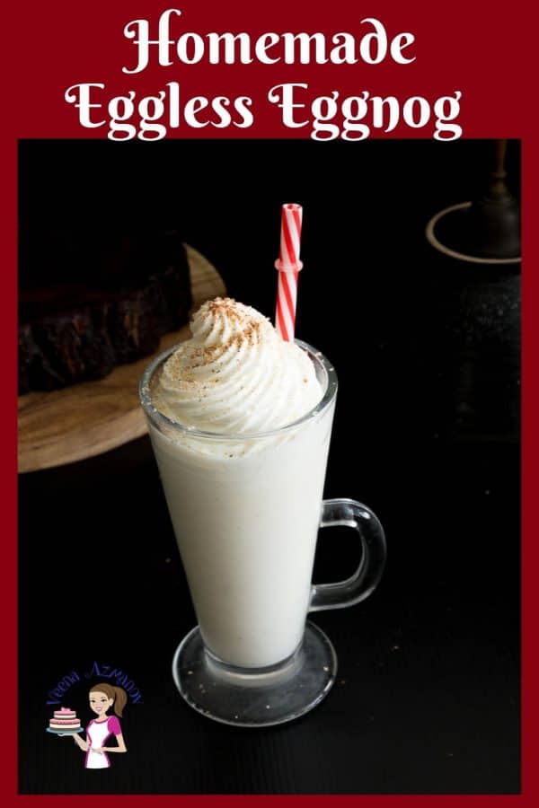 A tall glass of eggnog with whipped cream on top.