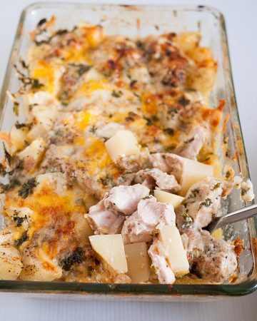 A glass casserole baked with chicken and potatoes.