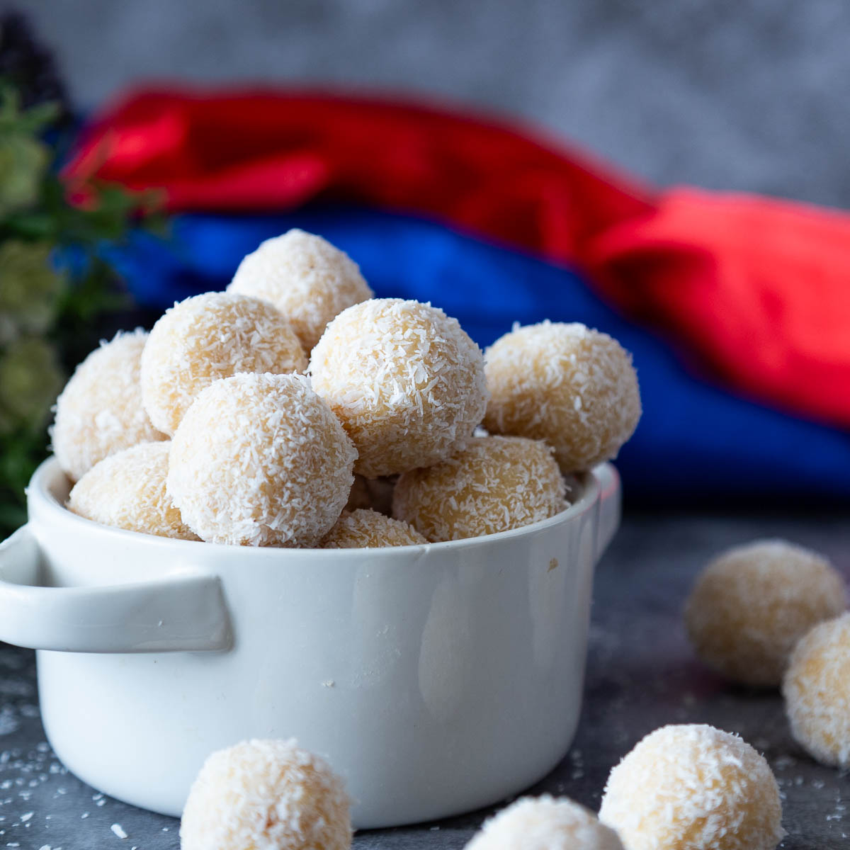 A white bowl with coconut balls.