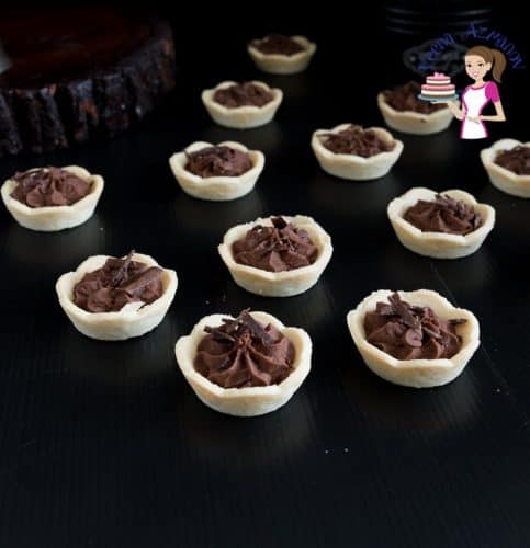 Mini chocolate mousse tarts on a table.
