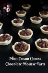 Mini chocolate mousse tarts on a table.