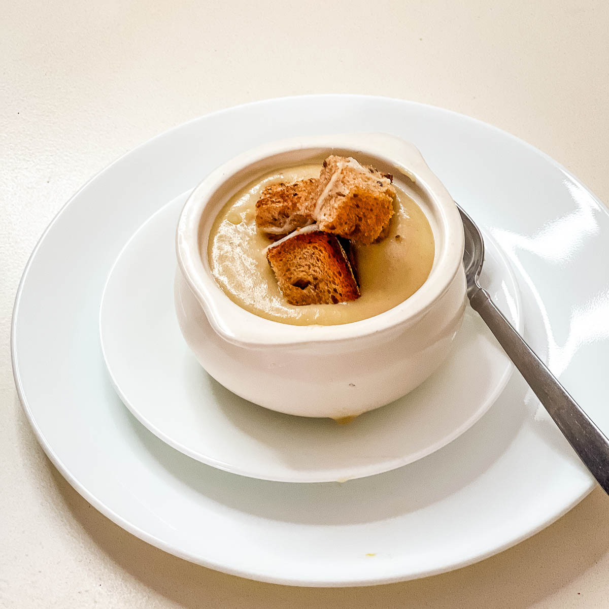 Potato soup in a white bowl with croutons,