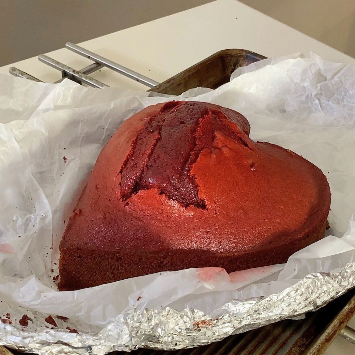 A baked red velvet heart cake.