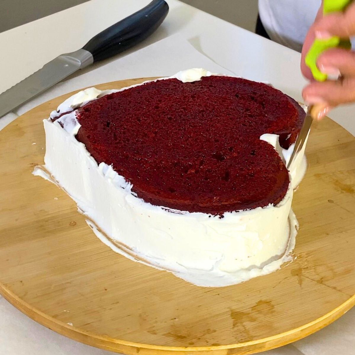 Frost the red velvet cake with whipped cream.