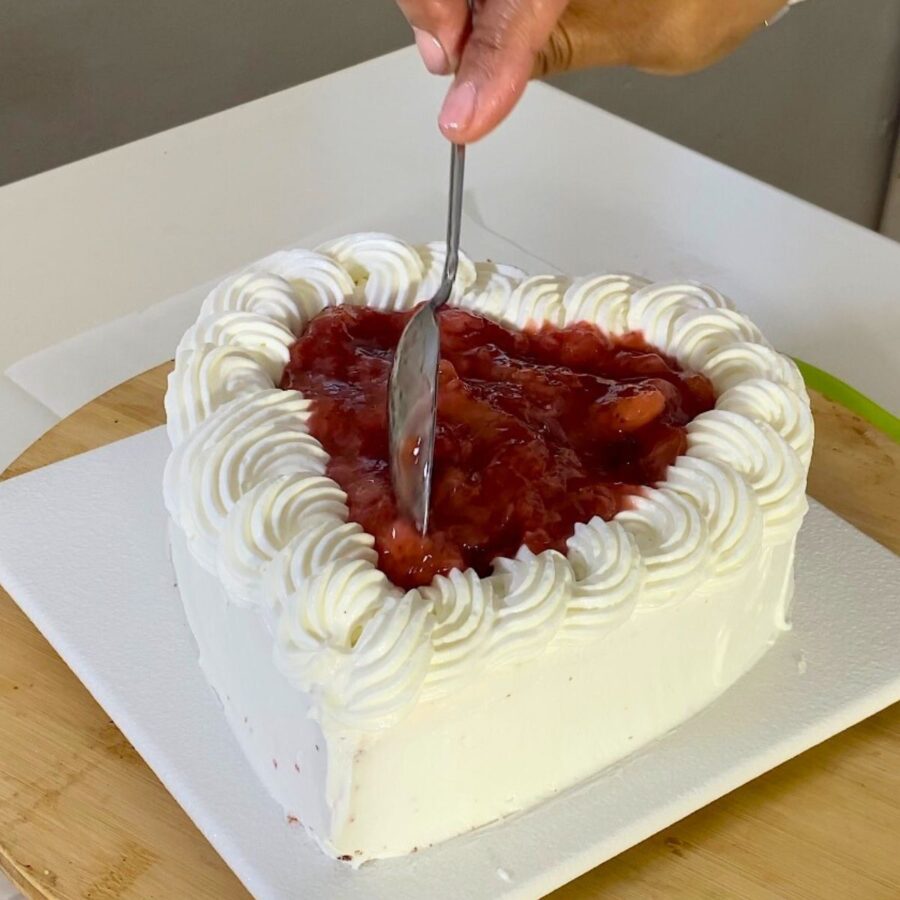Progress pictures adding strawberry filling to the heart pan.