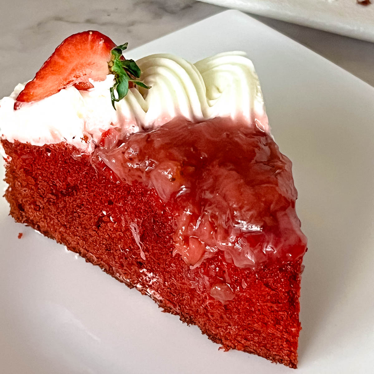 A slice of red velvet cake on the table.