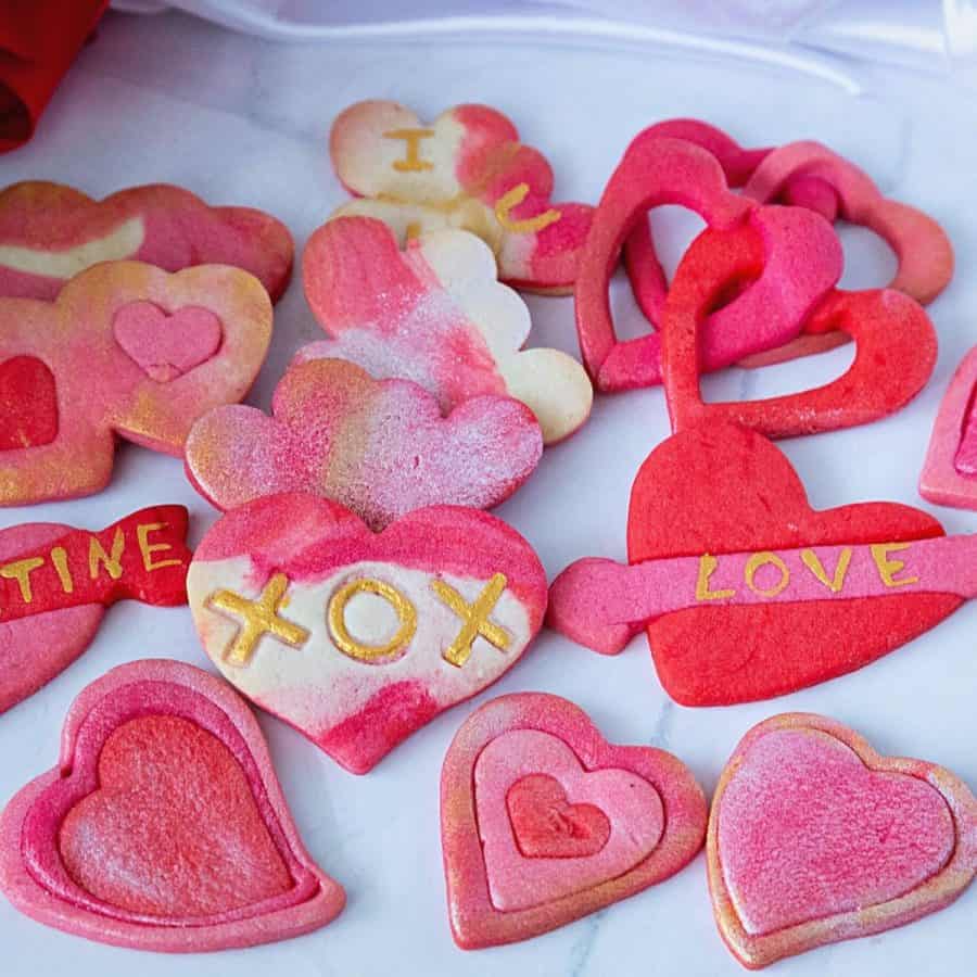 Assorted heart cookies marbled in pink.
