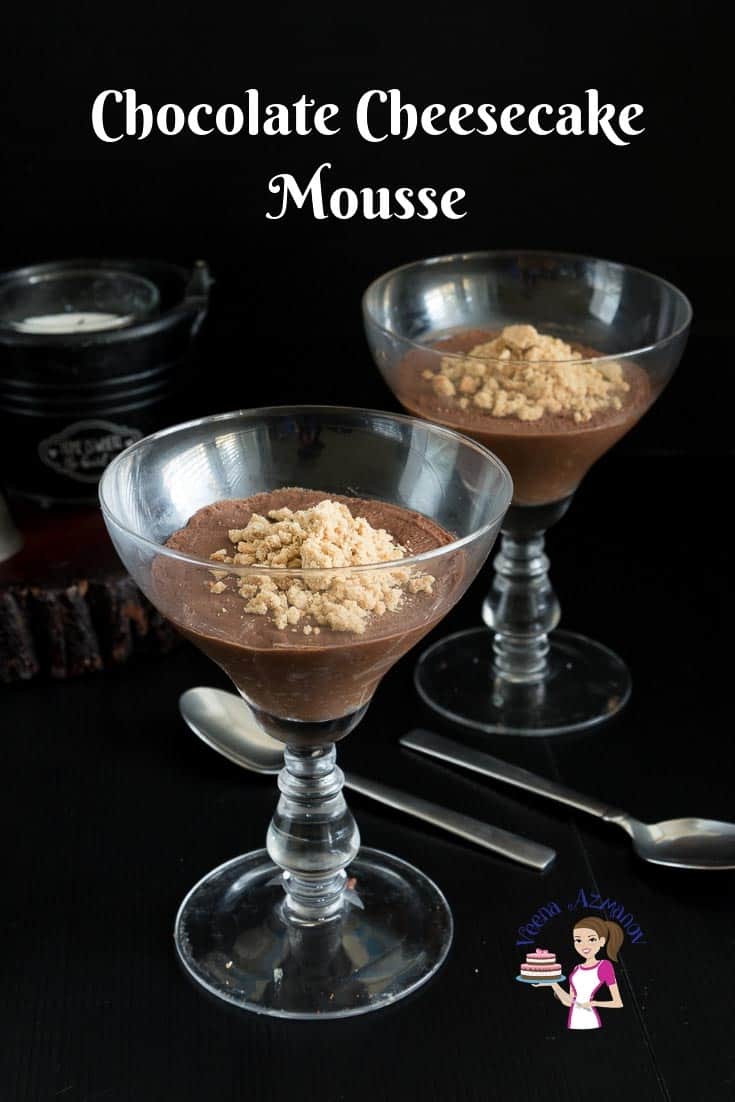 Two glasses of chocolate mousse on a table.