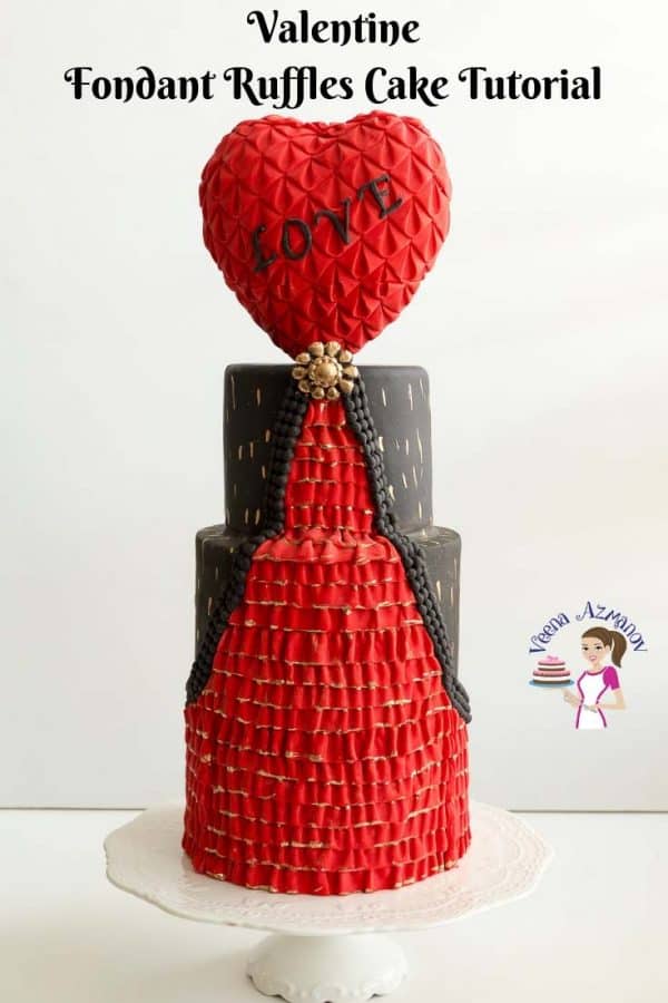 A Valentine's theme cake with a heart-shaped topper.