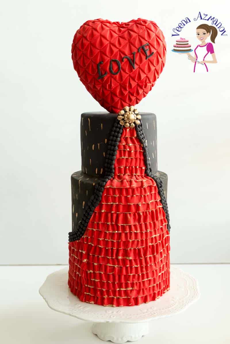 A Valentine\'s theme cake with a heart-shaped topper.