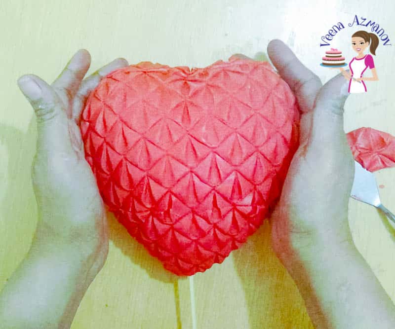 A heart-shaped cake topper.
