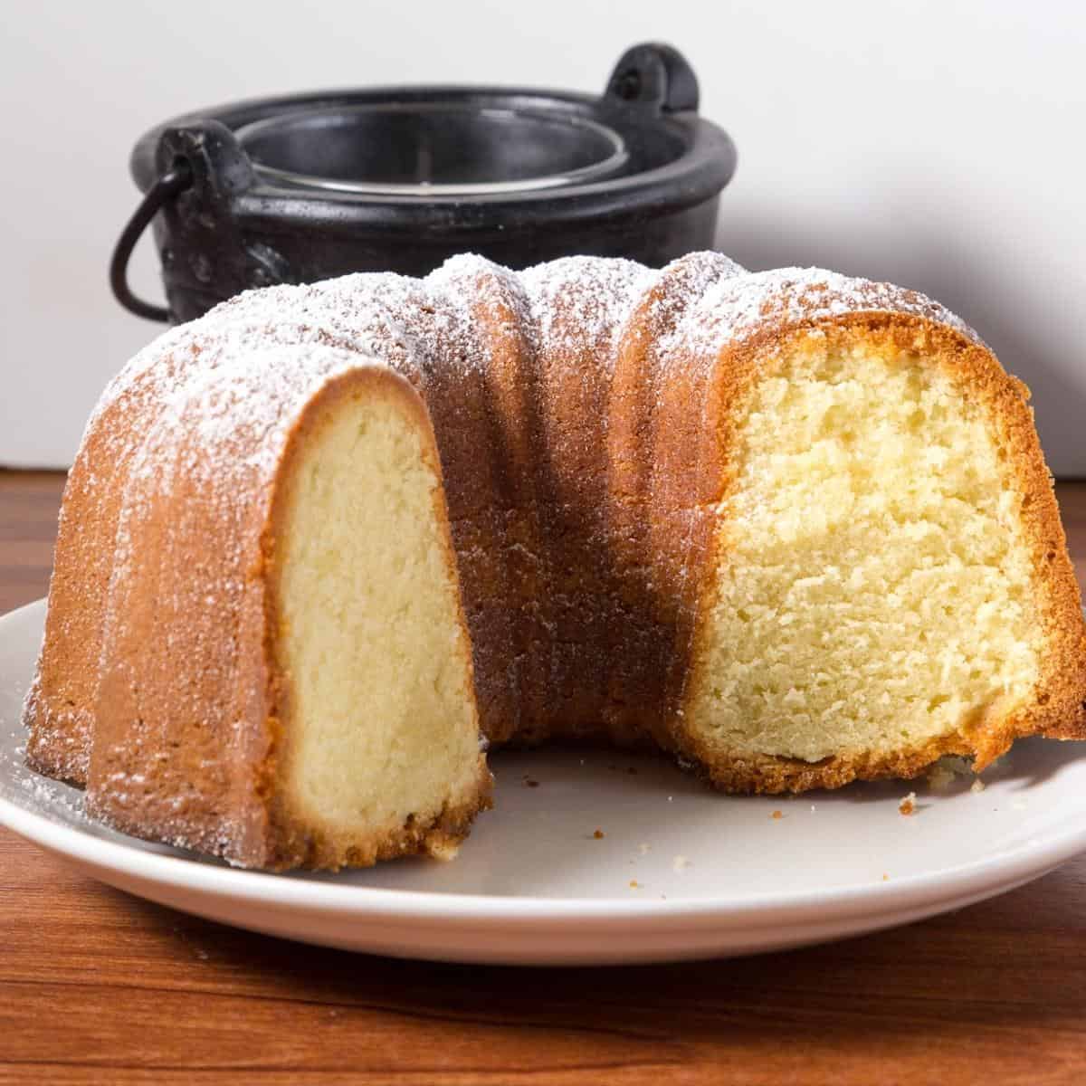 A cut vanilla bundt cake on a plate.