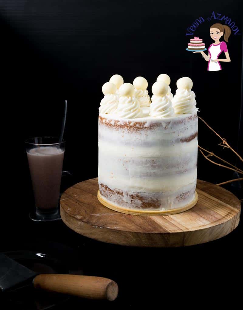 A naked layer cake on a stand.