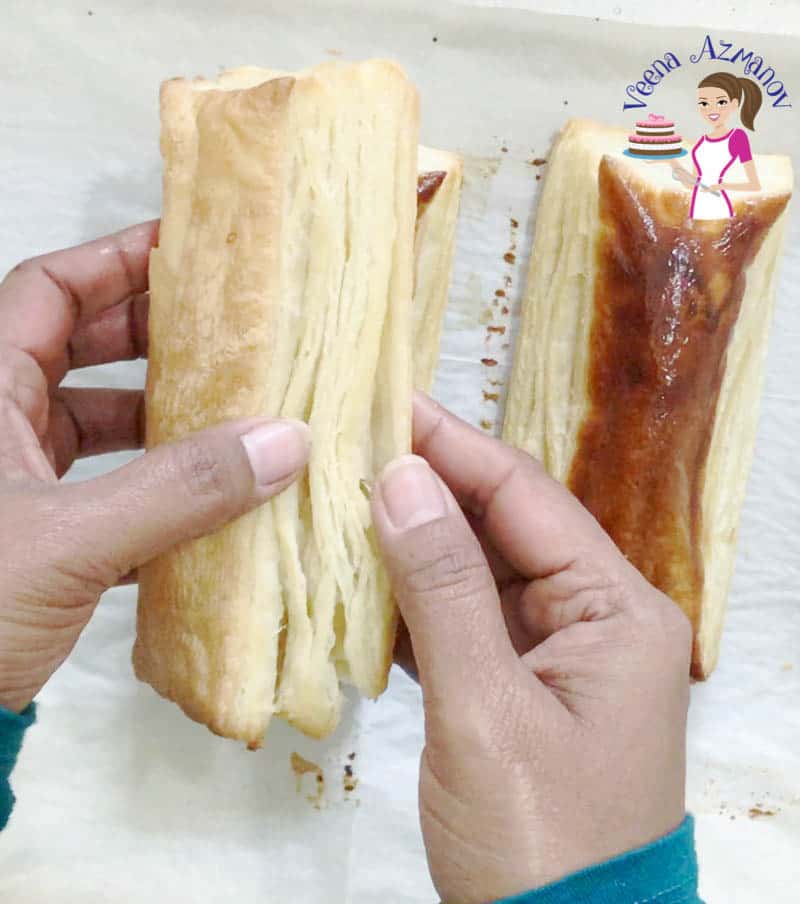 A person holding baked puff pastry.