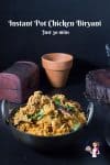 A bowl of chicken biryani on a table.
