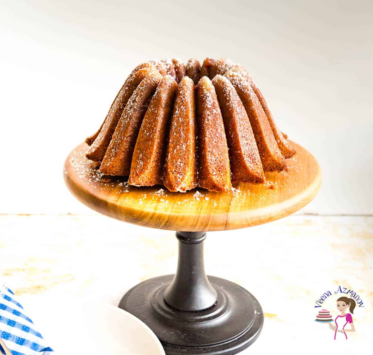 A bundt cake on a wooden cake stand