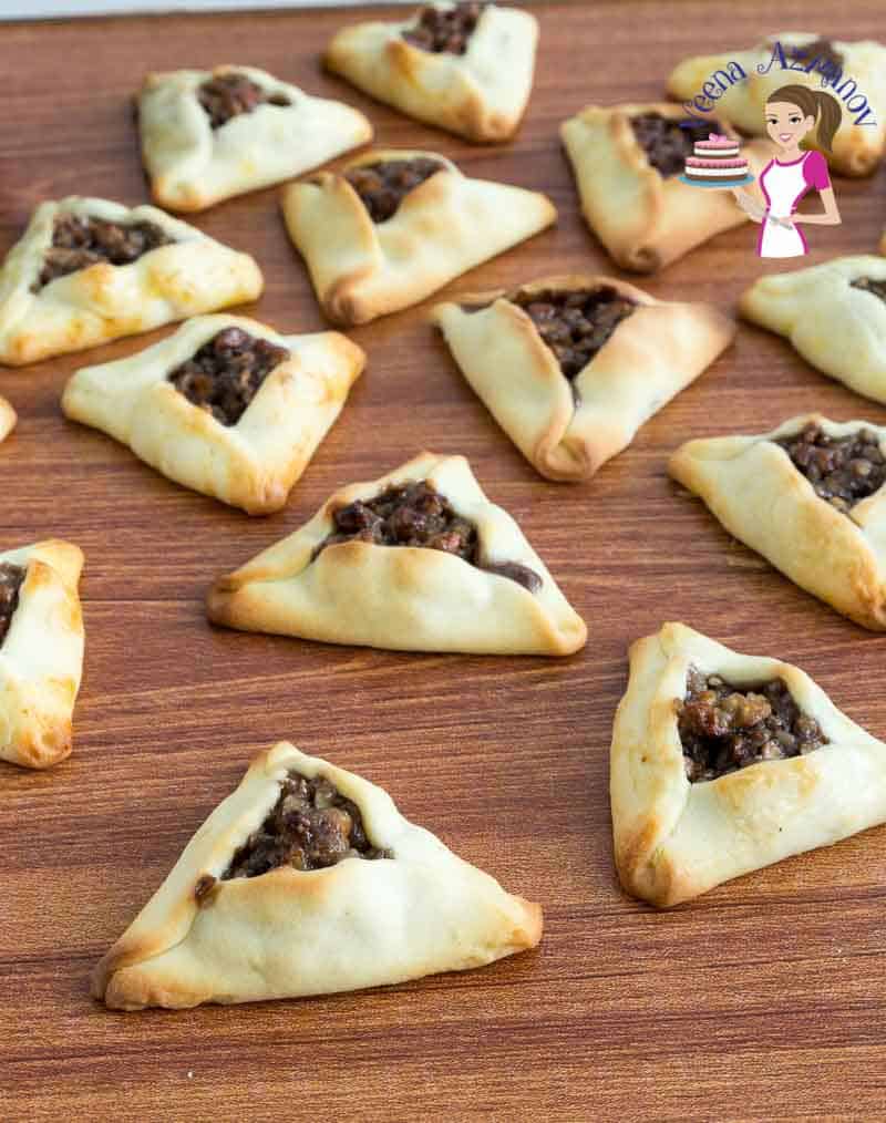 Pecan filled hamantaschen cookies on a table.