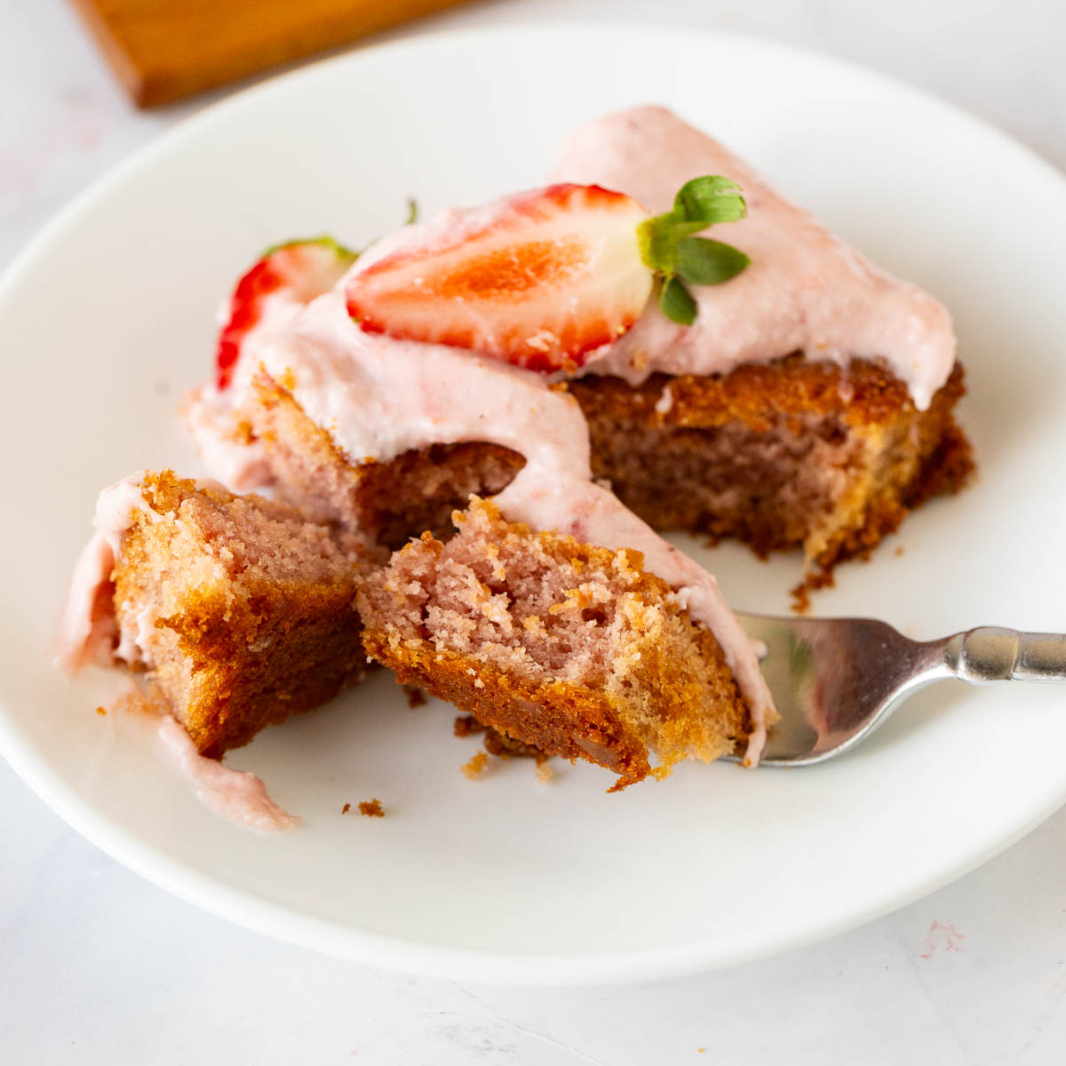 A slice of strawberry on a plate.