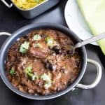 A bowl of black beans curry.