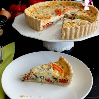 A slice of red peppers quiche on a plate.